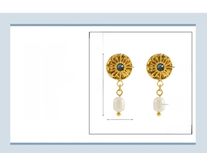 Detail of vintage sunburst earrings in 18K gold plated steel with pearls and blue rhinestones