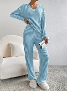 Detail of light blue V-neck knitted set with ribbed texture and wide-leg trousers