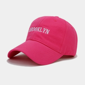 Detail of Brooklyn embroidery on bright fuchsia cotton twill baseball cap with curved brim