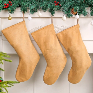 Three light brown sequin letter Christmas stockings hanging on a fireplace mantel