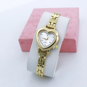 Close-up of heart-shaped gold quartz watch with rhinestone bezel in gift box