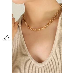 Detailed view of French vintage interlocking thick chain necklace in gold-plated stainless steel