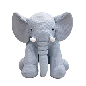 Soft light blue elephant plush toy with dotted texture fabric and ivory tusks
