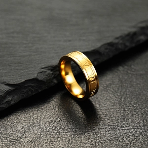 Golden 6mm stainless steel ring with Roman numeral engravings on a dark stone background
