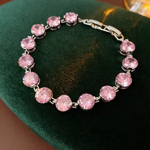 Court style bracelet with 14 round pink zircons in silver setting on green velvet