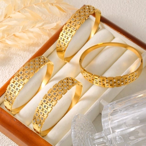 Set of four gold-plated stainless steel hollow bangles with clear cubic zirconia inlay