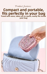 Pink glitter jewelry box being placed into a bag showing compact and portable size