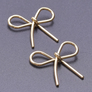 Macro shot of 304 stainless steel gold bow pendants for DIY jewelry making