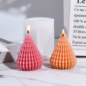 Detail of Christmas tree candle silicone mold with textured pine cone wax candles