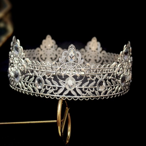 Macro detail of vintage Baroque crown with intricate silver metalwork and clear crystals