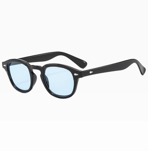 Side view of retro round glasses with black frame, blue lenses and silver arrow rivets
