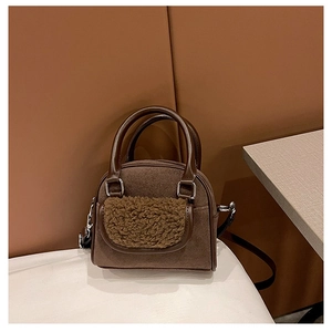 Detail of the vintage brown faux suede handbag with lamb wool trim and PU handles