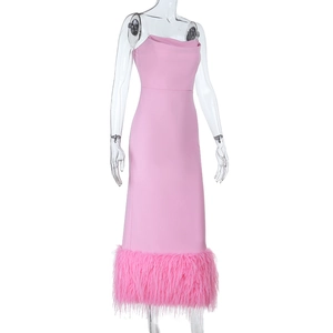Detail of pink bodycon dress featuring elegant faux feather trim at the bottom hem