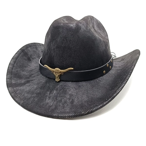 Detail of western cowboy hat featuring vintage bull head metal buckle and leather band