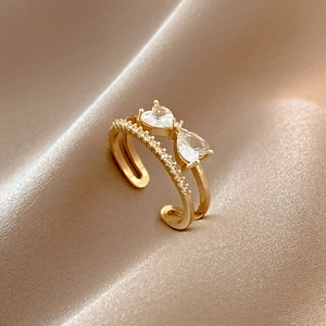 Golden double-layer open ring with two large heart-shaped crystals and zircon pave