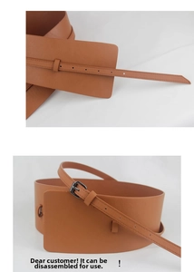 Detail of a brown double-layer wide waist belt with detachable thin strap and metal buckle