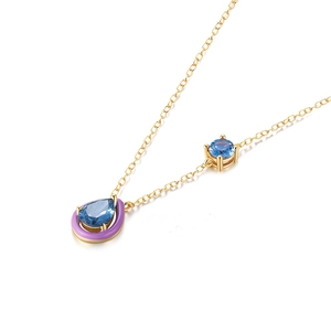 Detail of S925 sterling silver necklace with blue teardrop pendant and purple enamel accents