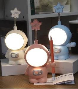 Cute astronaut desk lamps in white, pink and blue with glowing helmets for kids decor