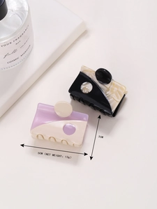 Close-up of small 5cm square acetate hair claws in marble and yin-yang patterns