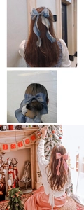 Detail of elegant pearl yarn bow hair clip with long ribbons in blue and pink