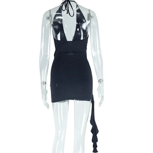 Detail of black halter backless mini dress with side ruffle trim on a display mannequin