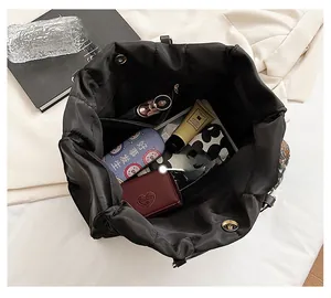 Top view of large black quilted tote bag showing spacious interior with magnetic closure
