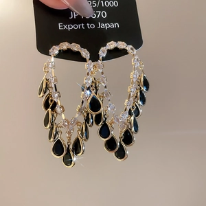 Detailed macro view of gold plated 18K tassel earrings with 925 silver needles