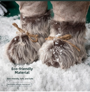 Close-up of Santa doll plush boots with burlap bow on snow background decor