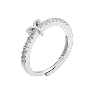 Close-up of polished silver adjustable ring featuring micro-pave zircon crystals and a knot design