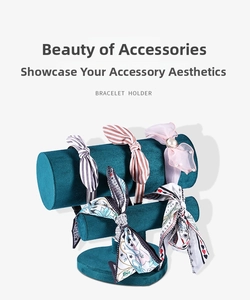 Detail of diverse bow headbands and floral hairbands on a teal velvet jewelry display