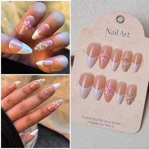 Almond French press-on nails with 3D floral accents, shell textures, and pearls