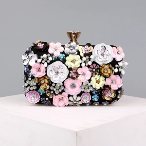 Detail of luxury evening clutch with colorful 3D flowers, sequins and crystal beads