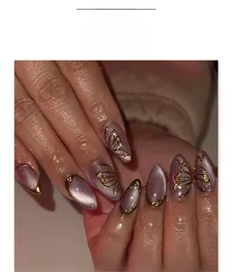 Detail of purple cat eye almond nails with 3D hand-painted gold butterflies