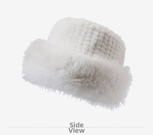 Close-up of white plush bucket hat featuring square knit top and fluffy faux fur trim