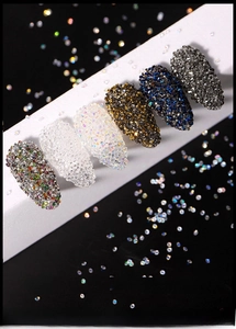 Macro view of six-color iridescent nail art micro beads on white display strips