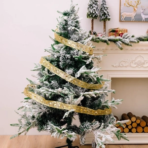 Detail of gold ribbon with star patterns on a flocked Christmas tree with snow effects