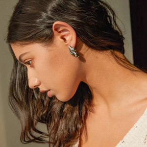 Minimalist silver finish 18k gold stainless steel water drop earrings worn by model