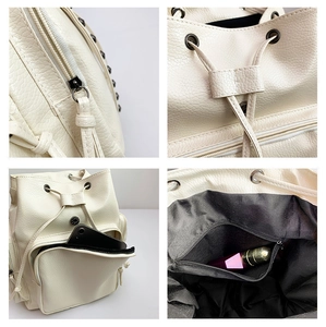 Detail view of white PU leather backpack featuring drawstring closure and zipper pockets
