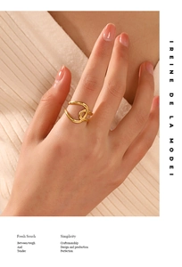 Close-up of 18K gold plated stainless steel twisted knot ring on finger with warm tones