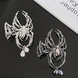 Detailed view of spider hair claws with rhinestones and pearl drops in silver and black