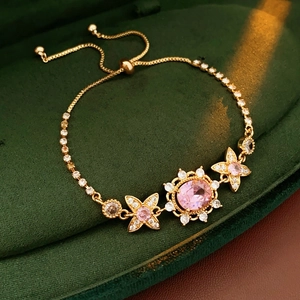 Elegant gold flower bracelet with pink and white gems in a luxury velvet jewelry box