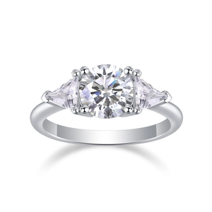 Macro shot of silver three-stone ring with round main moissanite and triangle side stones