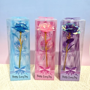 Three gold foil roses in blue, pink, and purple gift boxes with golden stems and leaves