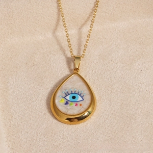 Detail of water-drop evil eye pendant with colorful hearts on a gold cable chain