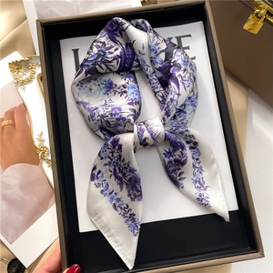 Floral bird print silk scarf in white and blue, elegantly displayed in a brown gift box