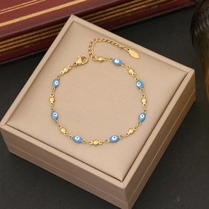 Close-up of golden Evil Eye bracelet with blue enamel charms and adjustable lobster clasp