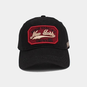 Detail of black cotton baseball cap with red vintage embroidery and side letter stitching