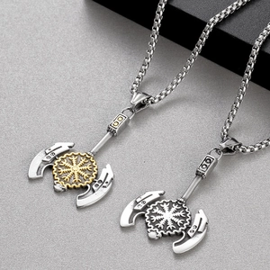 Detail of Viking axe pendants with compass runes in silver and two-tone gold finishes