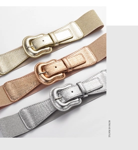 Three elastic belts in gold, rose gold and silver with metallic buckles and leather trim