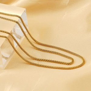 Versatile 18K gold-plated stainless steel mesh chain necklace on beige silk fabric